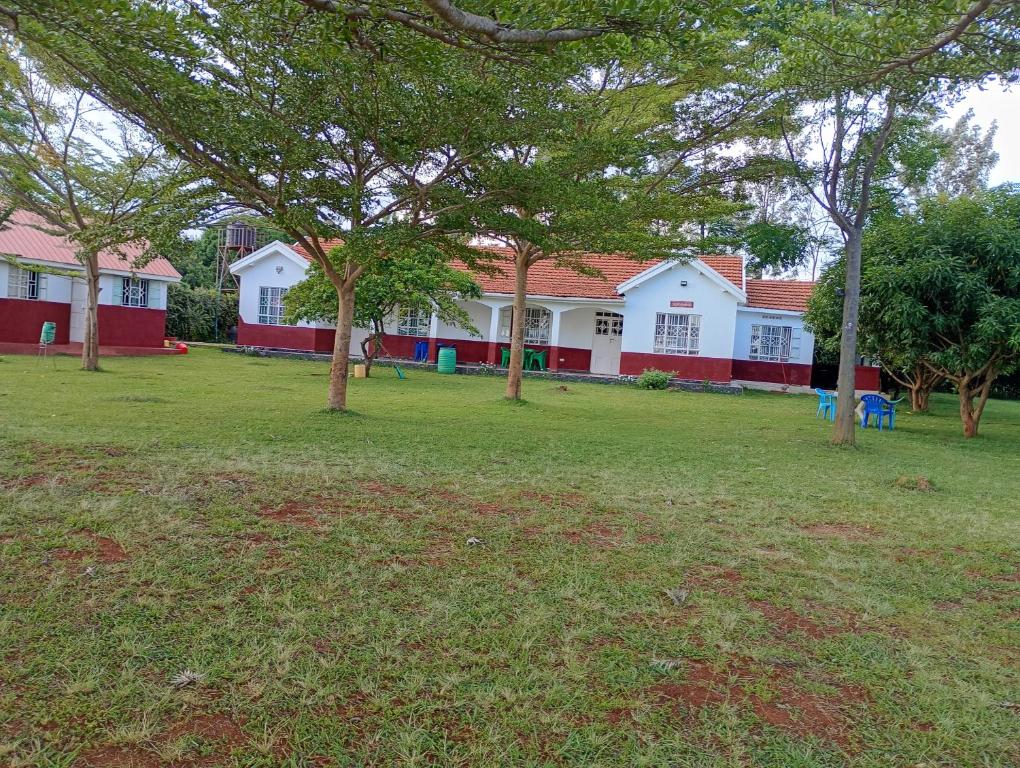 a group of houses with trees in a yard at Lakeside Beach Hotel in Madwa