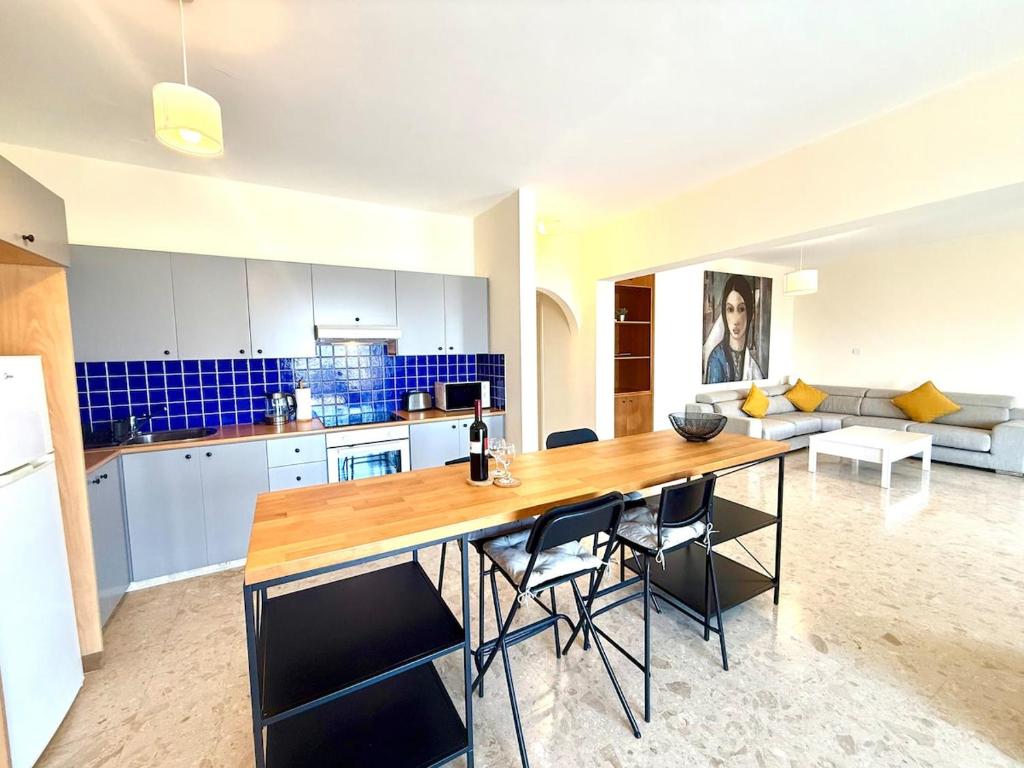 a kitchen with a large wooden table and chairs at Latchi Marina in Lachi