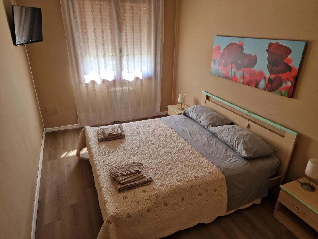a bedroom with a bed with two towels on it at Casa Gemma in Padova