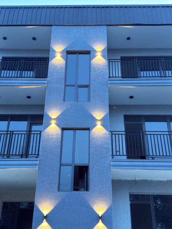 a building with lights on the side of it at Mzeonas Apartment in Kobuleti