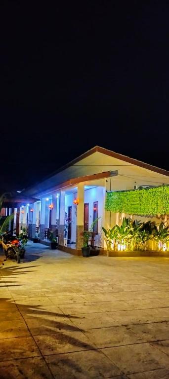 a building with blue lights on it at night at Hotel Shandira in Taliwang