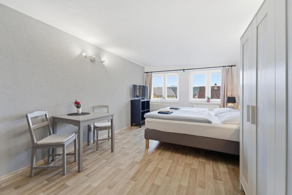 a bedroom with a bed and a desk and a table at Apartmán Plasy in Plasy
