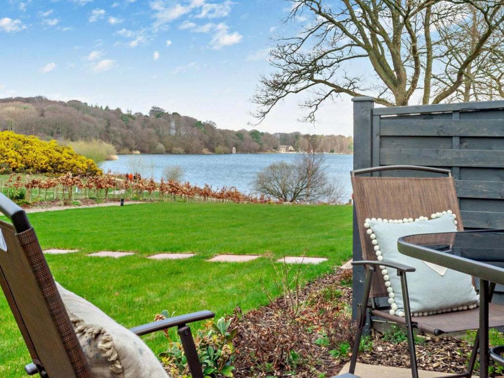 a patio with a table and chairs and a view of a lake at 2 Bed in Brampton oc-91822 in Brampton