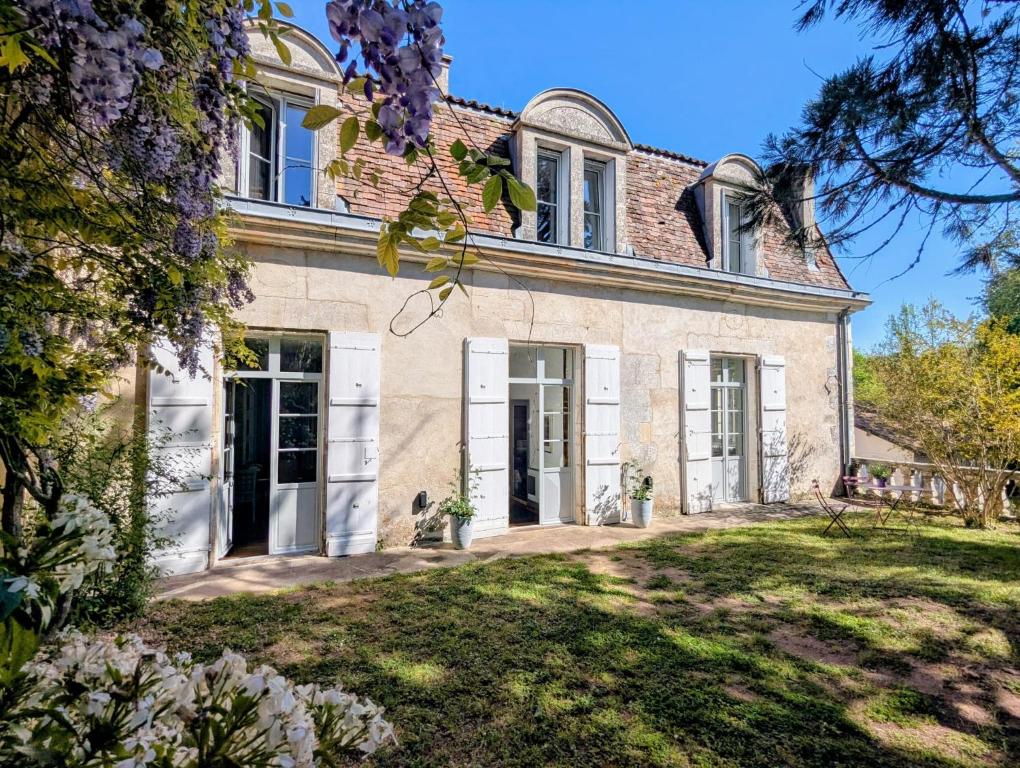 an exterior view of a house with a yard at Domaine de la Dordrona in Brantome en Perigord