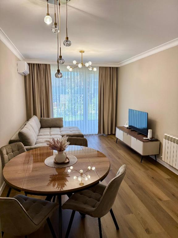 a living room with a table and a couch at Luxury Apartment Sofia in Sofia