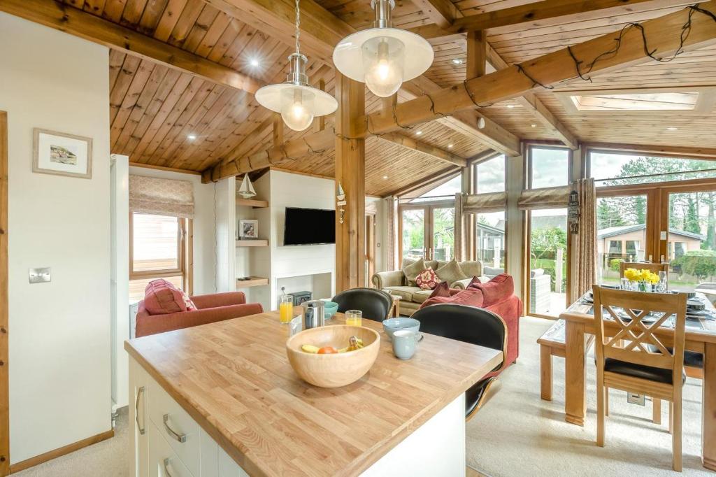 a kitchen and living room with a wooden ceiling at 3 Bed in Whitby oc-wa057 in Runswick