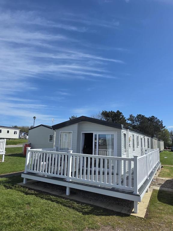 a large white mobile home with a white porch at 8 Berth Caravan - Blue Dolphin - Filey in Gristhorpe