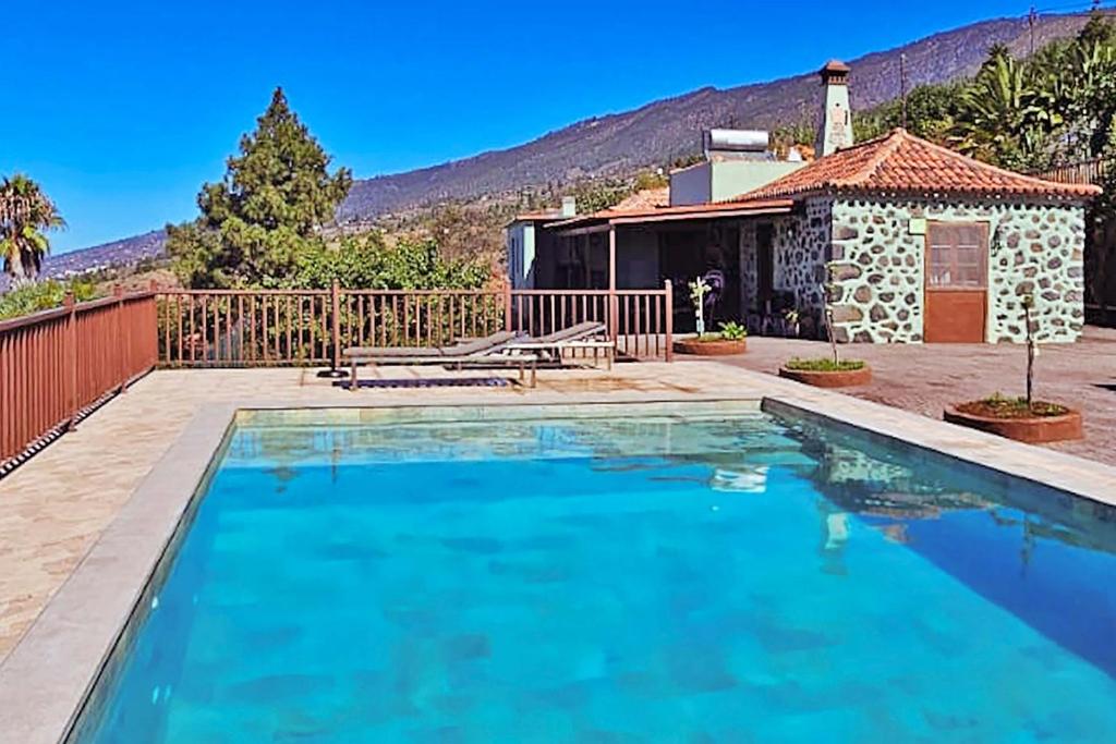 a swimming pool in front of a house at Casa Tia Rosalia in Tijarafe