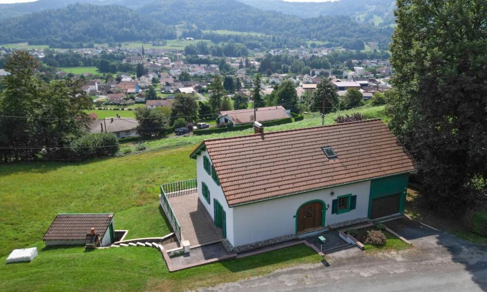 a small house on top of a green field at La Fermette du Patural in Ramonchamp