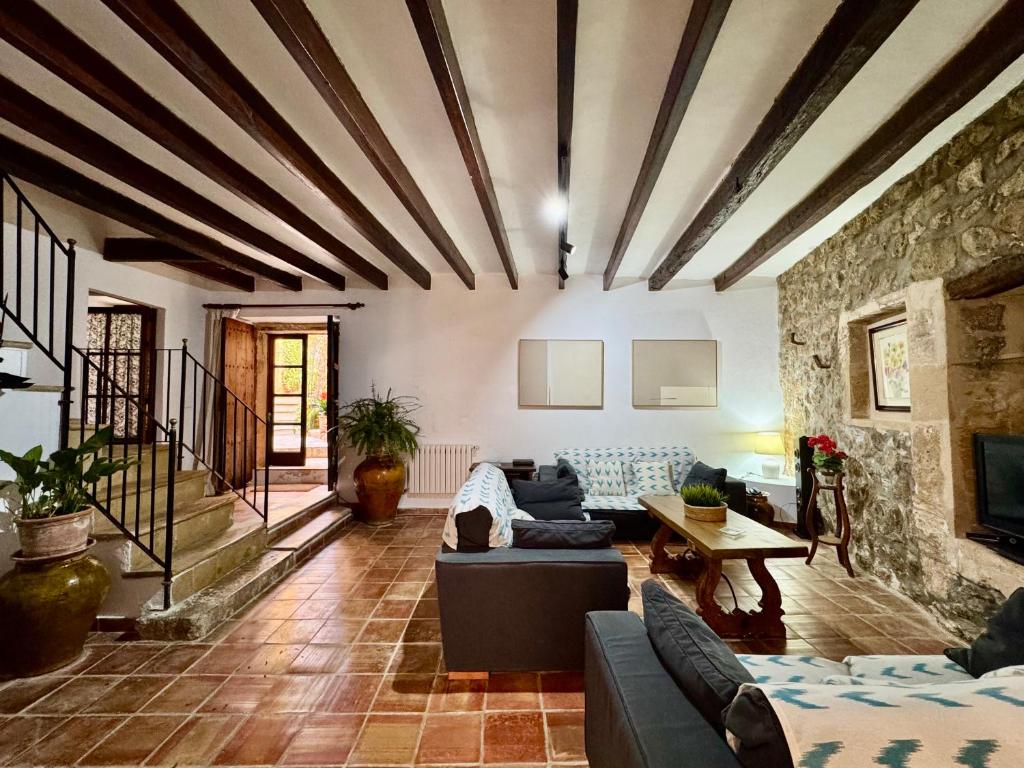 a living room with a couch and a table at Calvario Townhouse by rentavillamallorca in Pollença