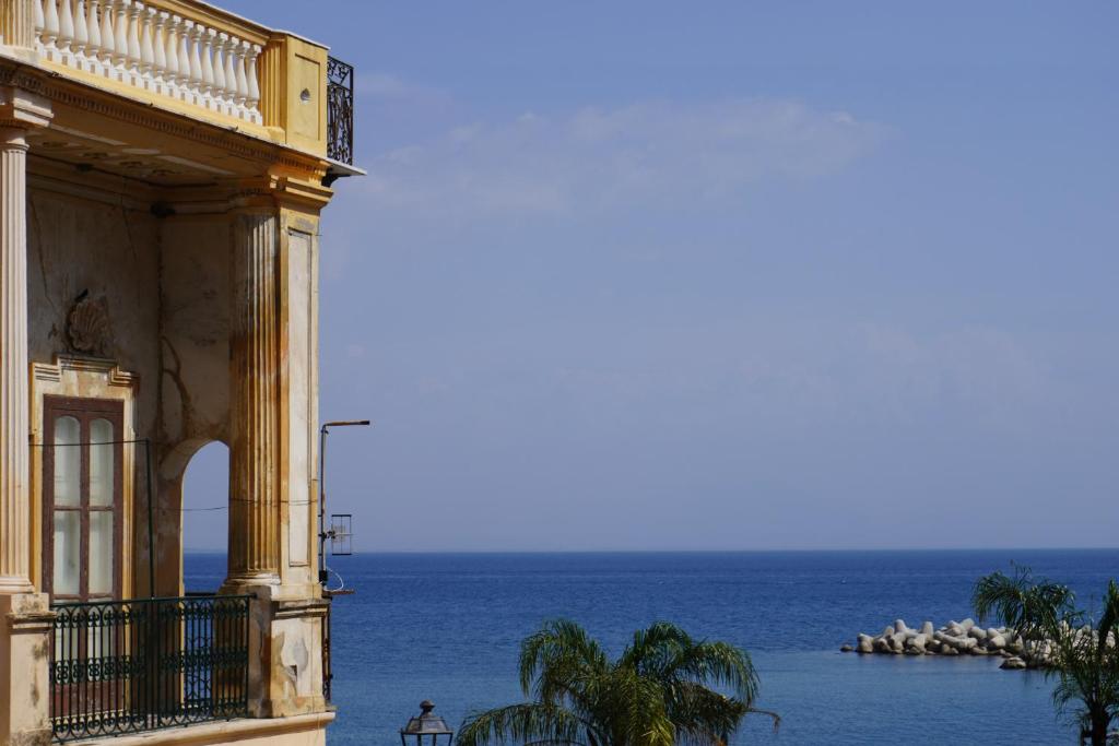 a building with the ocean in the background at A casa di Gennarino in Cetara