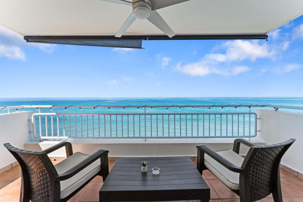 a balcony with a table and chairs and the ocean at Beachfront apt with amazing views in Stella