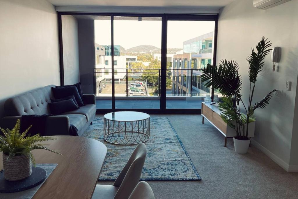 a living room with a couch and a table at Big, Bold, Barton in Barton