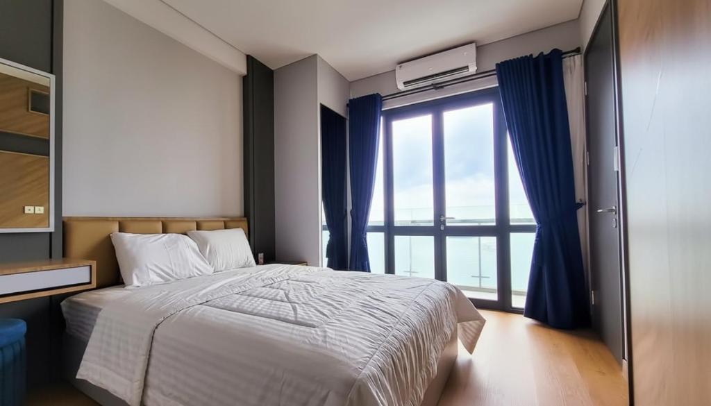 a bedroom with a bed and a large window at 3 Bed Room One Residence by momo in Pulau Sembakau Kecil