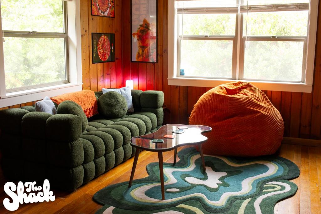 a living room with a couch and a table at The Shack at Long Beach - A Psychedelic Getaway in Long Beach