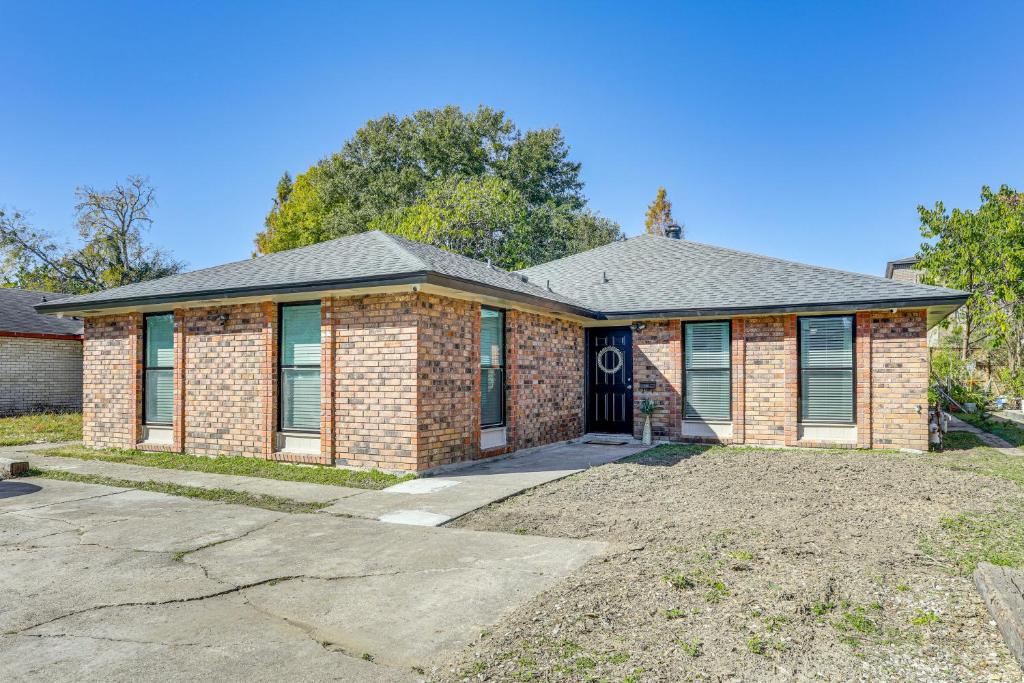 a brick house with a driveway in front of it at Tiger Town Retreat: Spacious 3-Home Retreat! in Baton Rouge