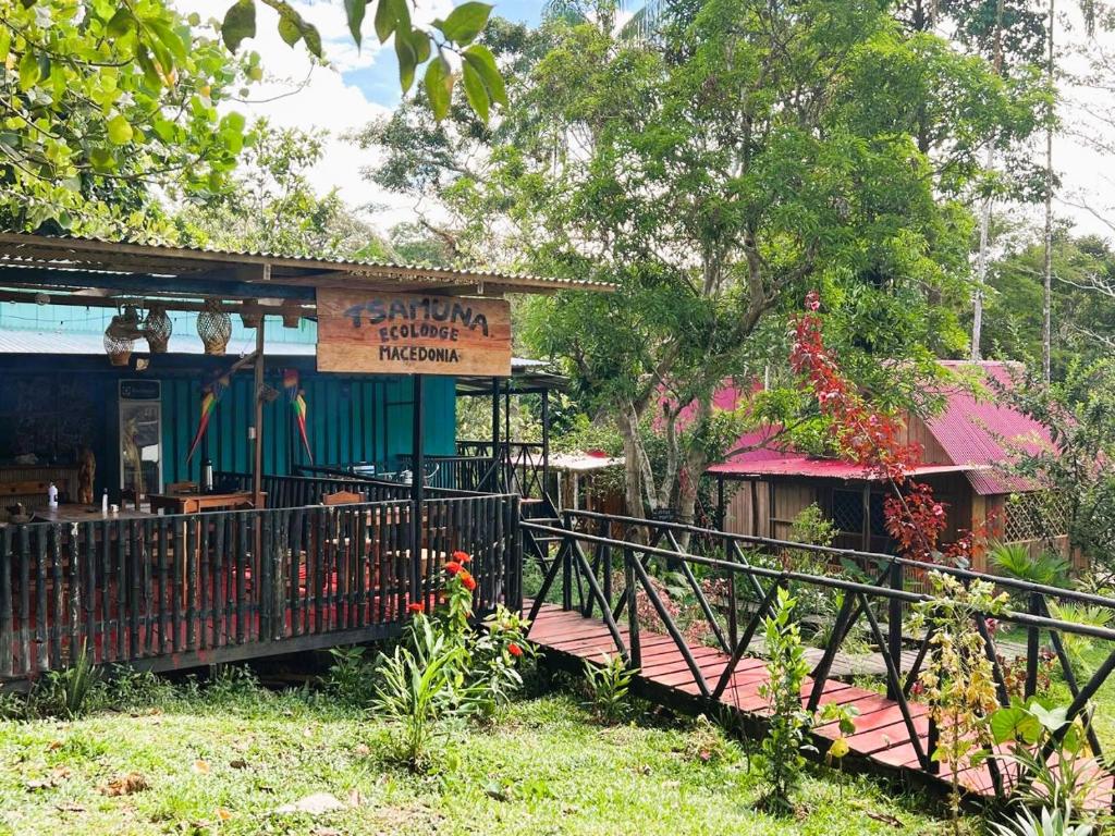 a restaurant with a wooden deck in front of a building at Tsamuna Ecolodge Macedonia in Macedonia