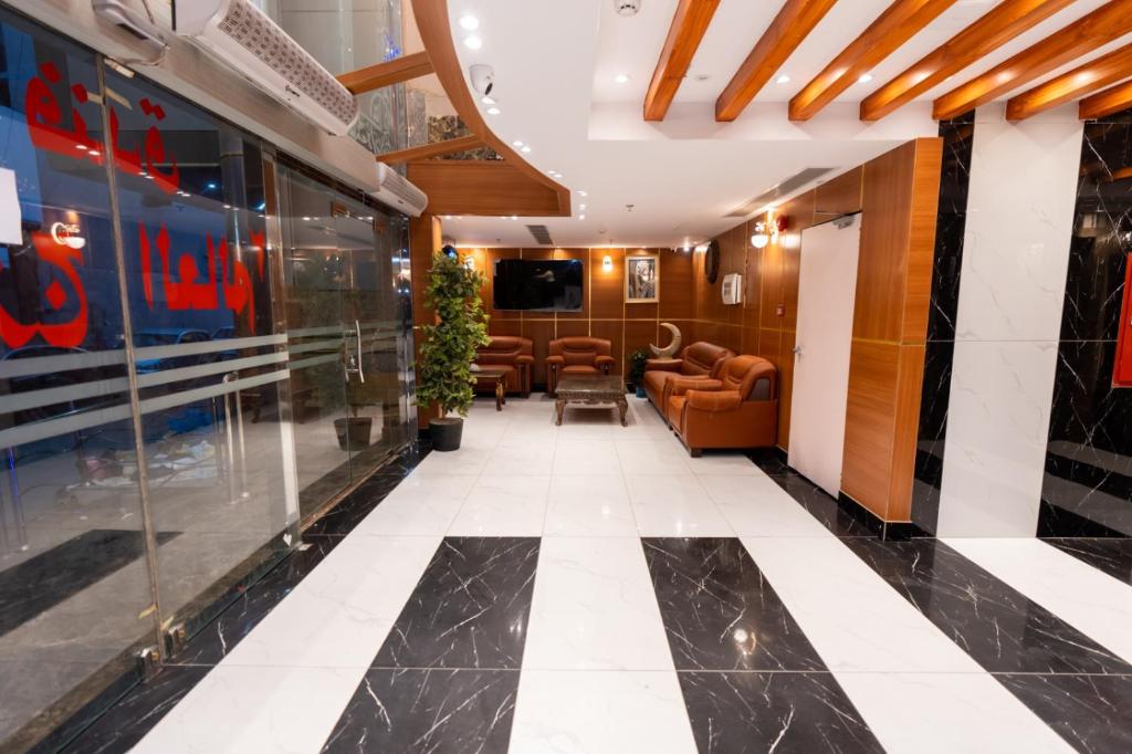 a lobby with couches and a tv in a building at فندق برج العالم 2 in Mecca