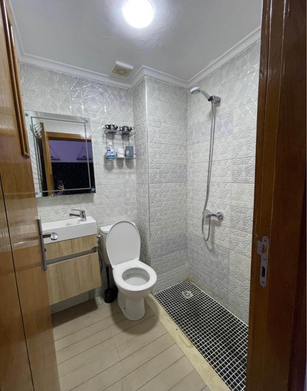 a bathroom with a shower and a toilet and a sink at saviohome in Ouarzazate
