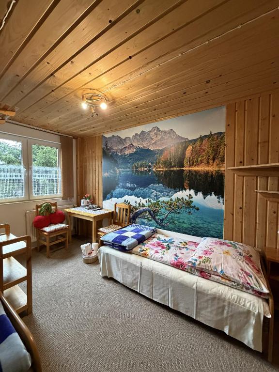 a bedroom with a large painting on the wall at ANTON Tenczyn in Tenczyn
