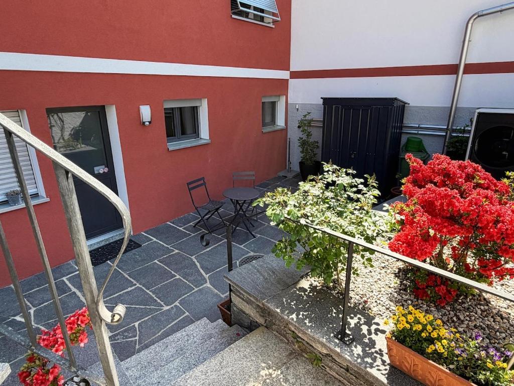 a balcony of a building with flowers on it at Ca' dal Bagatt Losone Campagna in Losone