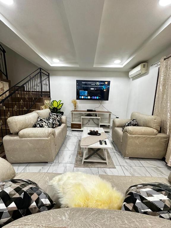 a living room with couches and a flat screen tv at Casa Privé, Comayagua in Comayagua