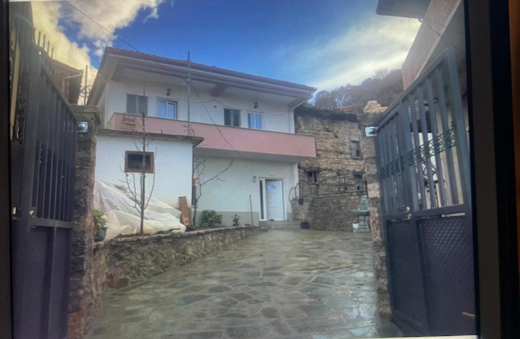 a stone walkway leading to a building with a gate at Vila Du Lac Blue in Lin