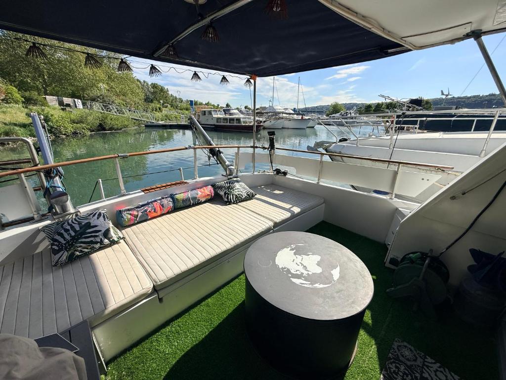 a boat with a wooden deck with a table on it at Aquareve-location in Valence
