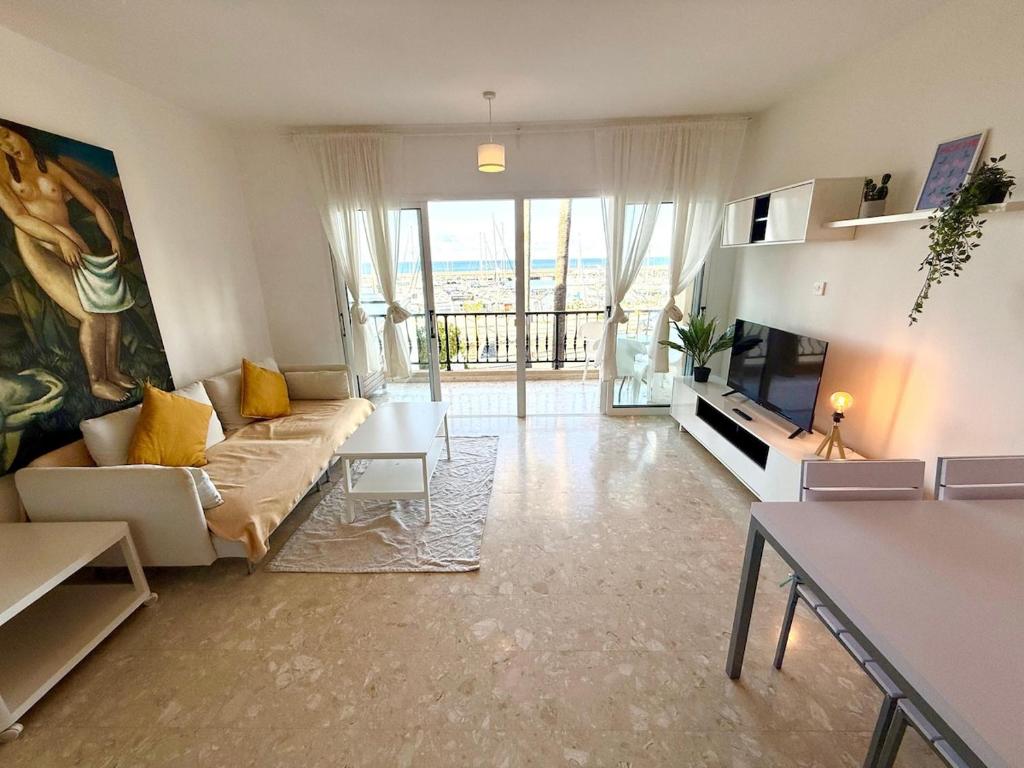 a living room with a couch and a tv at Latchi Premium View in Lachi