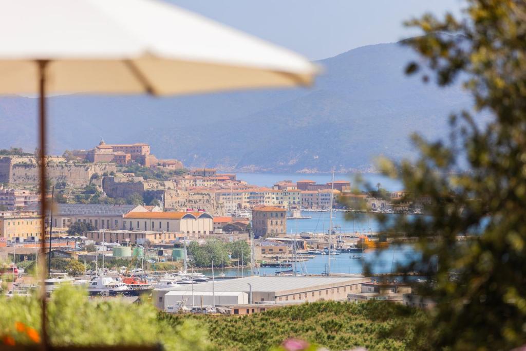 a view of a city with an umbrella and a harbor at Appartamenti Bellavista by ElbaSummer in Portoferraio