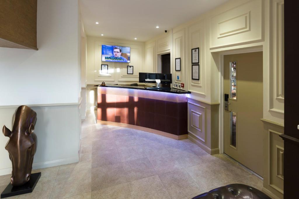 a lobby with a bar in a building at Dreams Hotel in Barking