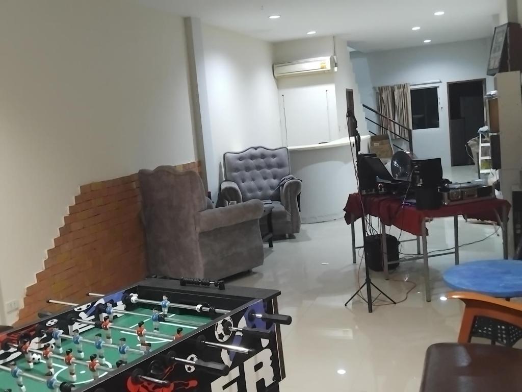 a living room with a foos ball on a table at Sunset Groove Cafe in Nong Prue