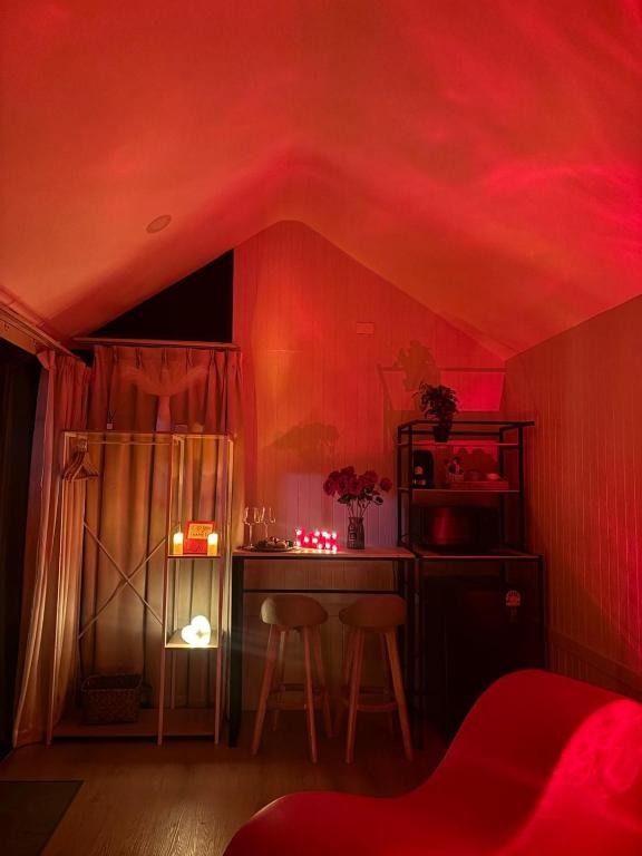 a room with a red ceiling with a table and chairs at Tiny Love Room in Ao Nang Beach