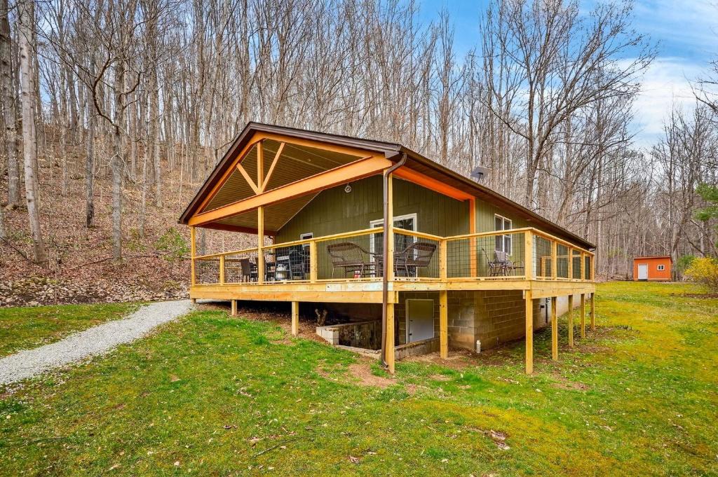 a large house with a large deck in a field at Lane's End in Laurelville