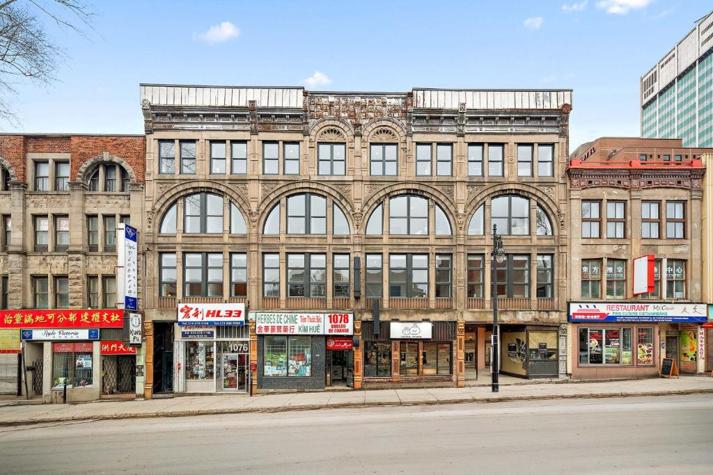 a large brick building on the corner of a street at Le Nomade Quartier Chinois in Montreal