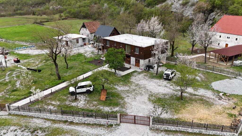 an aerial view of a house with a truck parked in the yard at xhovani zelna in Theth