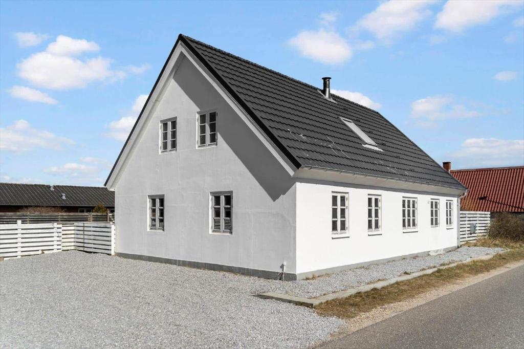 a white house with a black roof at 1073-Thisted-Orhagevej-30 in Klitmøller