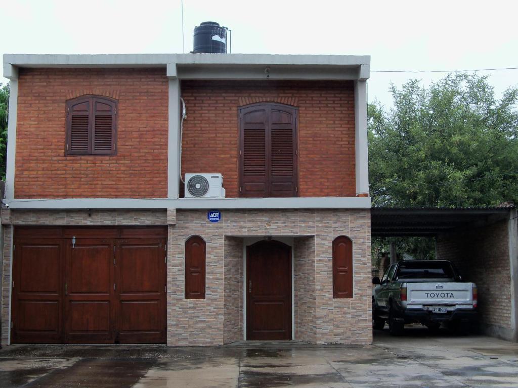 a brick house with two garage doors at Casa Jugo in Santiago del Estero