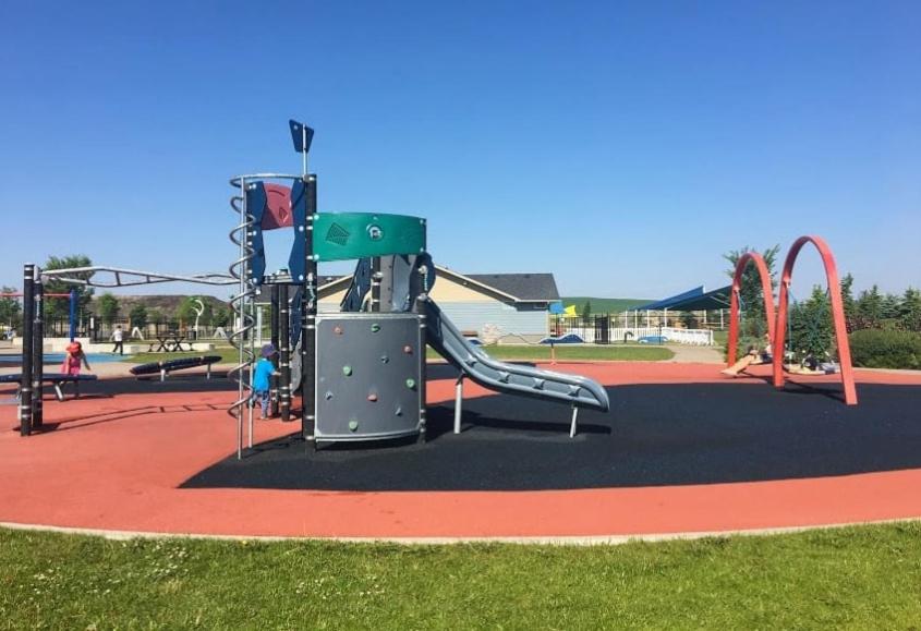 a playground with a slide in a park at Cobblebrook Executive Suites in Airdrie