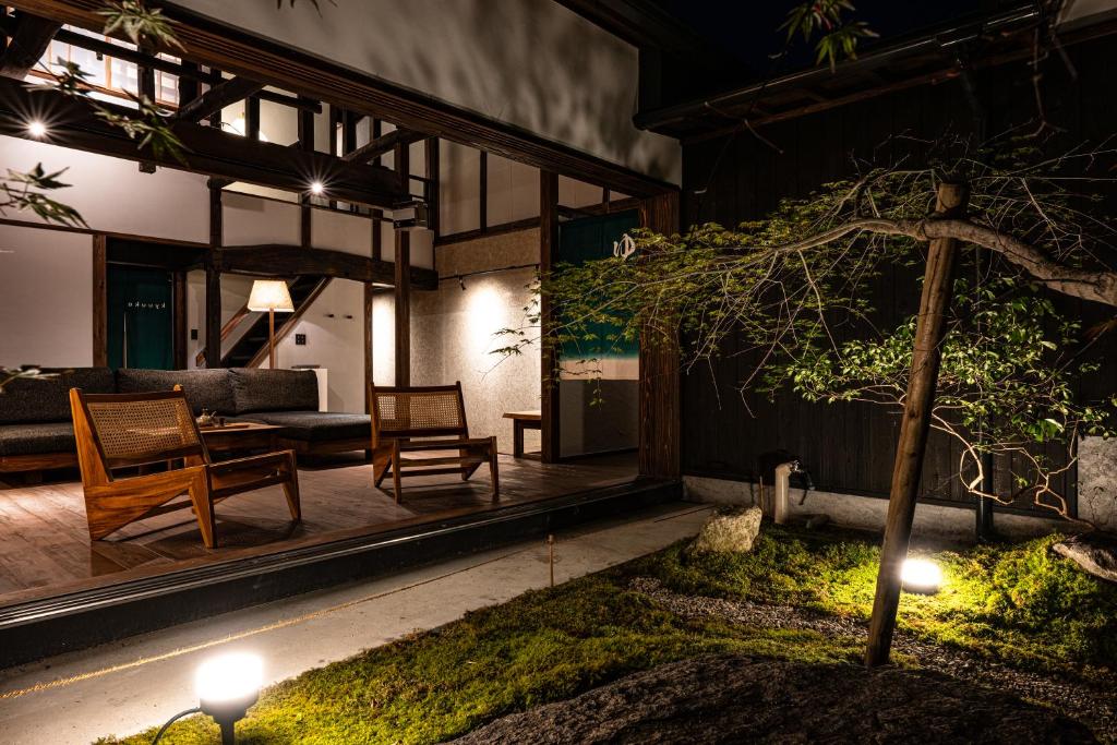 ein Wohnzimmer eines Hauses mit einem Baum in der Unterkunft kyuuka in Nakatsu
