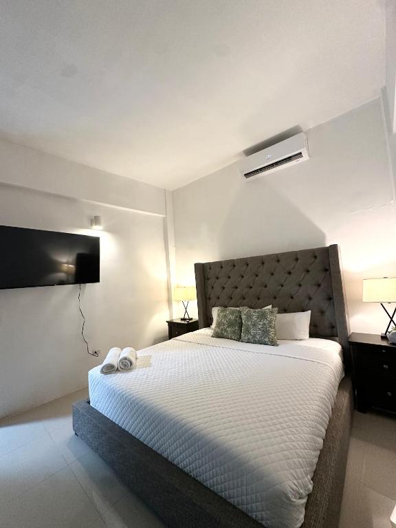 a bedroom with a bed with two pillows on it at La Estadia in San Juan