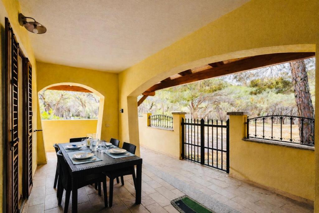 a dining room with a table and a balcony at Lucia House in Santa Lucia