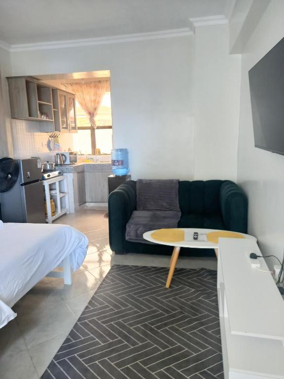 a living room with a couch and a coffee table at Tulivu Homes in Meru