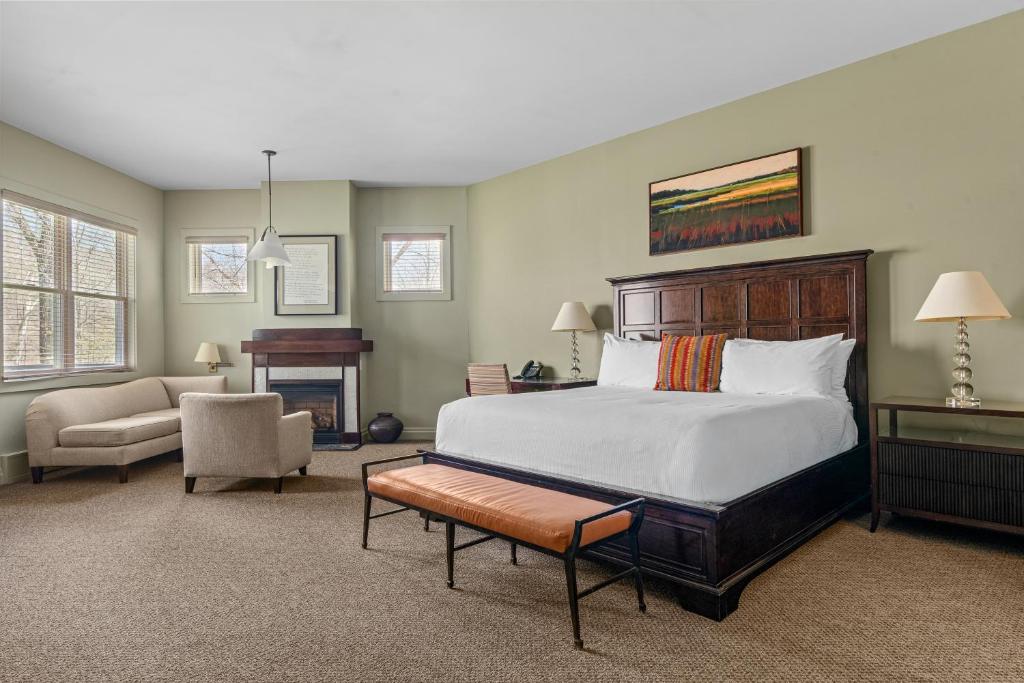 a bedroom with a bed and a chair and a table at Emerson Resort & Spa in Mount Tremper
