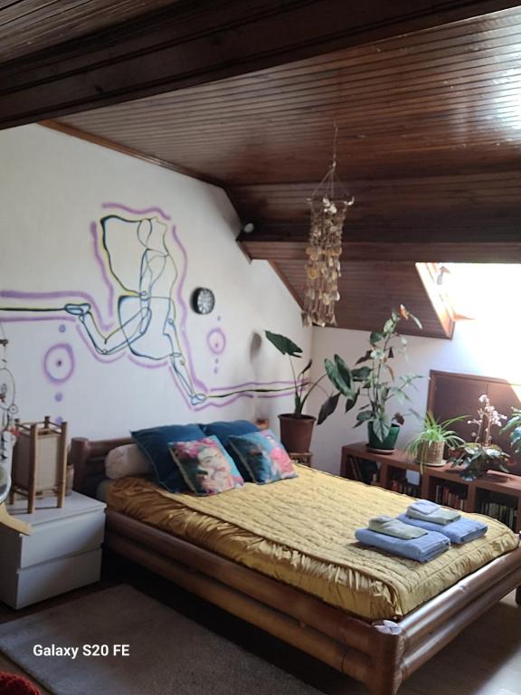 a bedroom with a bed with a map on the wall at Le Grenier d'Artiste in Laguépie