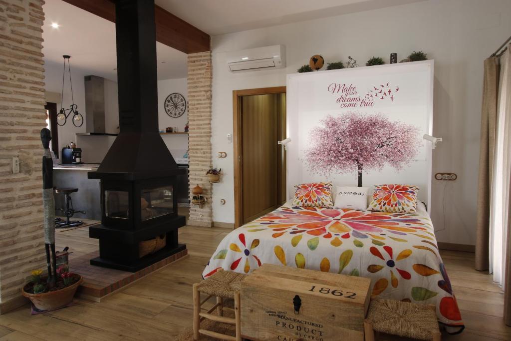 a bedroom with a bed with a tree on it at La Cambra casa rural Premium in Potríes