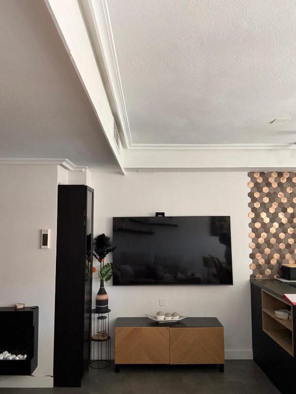 a living room with a large flat screen tv on a wall at Casa de ogracia in Rojales