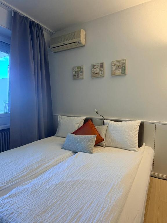a bedroom with a white bed with pillows on it at QuietApartment in Bellinzona
