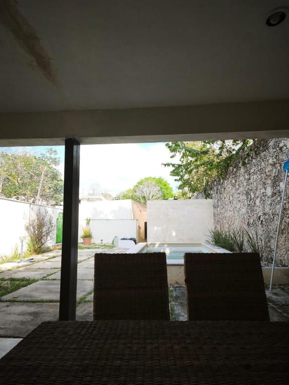 two chairs sitting on a table in a yard at Santuario del Sol in Mérida