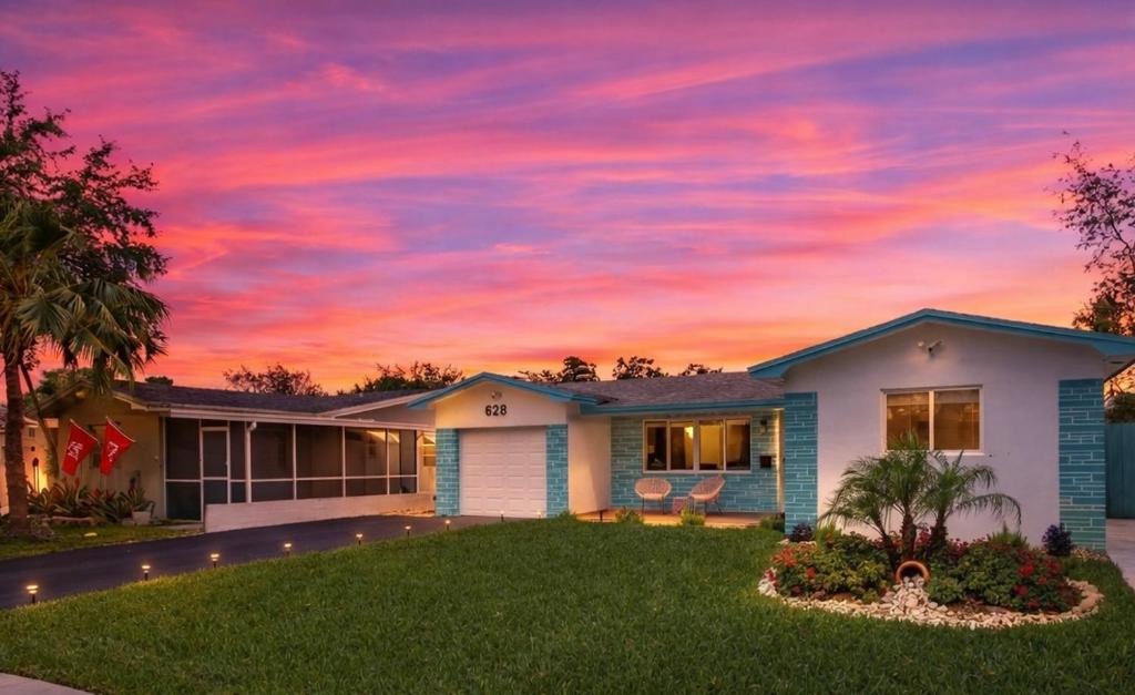 a house with a sunset in the sky at Ebenezer Home in Hallandale Beach